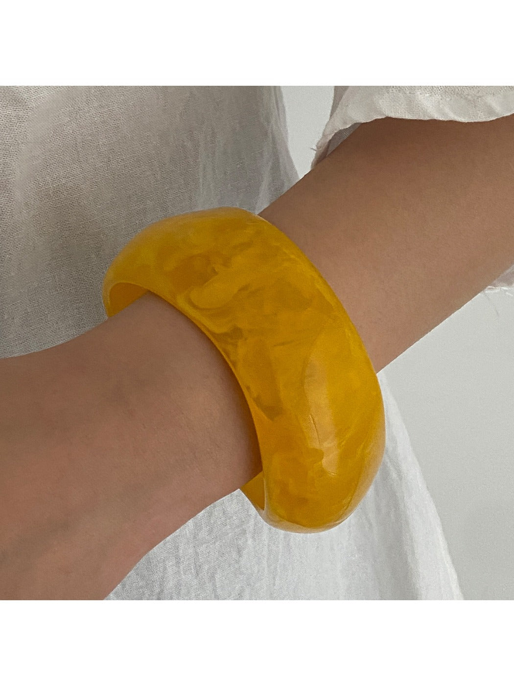 Lovra wide round bangle bracelet worn on wrist showcasing its wide band design