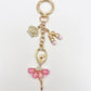 Ballerina charm keychain placed on a white surface with soft lighting