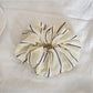 Yellow stripe print scrunchie styled on a wrist as an accessory