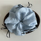 Close-up of the textured tulle fabric and ribbon bow detail on the scrunchie