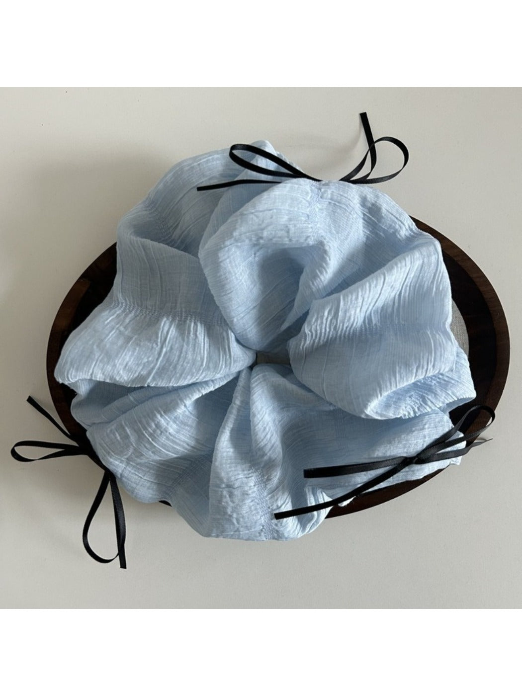 Close-up of the textured tulle fabric and ribbon bow detail on the scrunchie