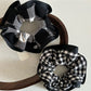 Close-up of black edge detail on black and white check scrunchie fabric