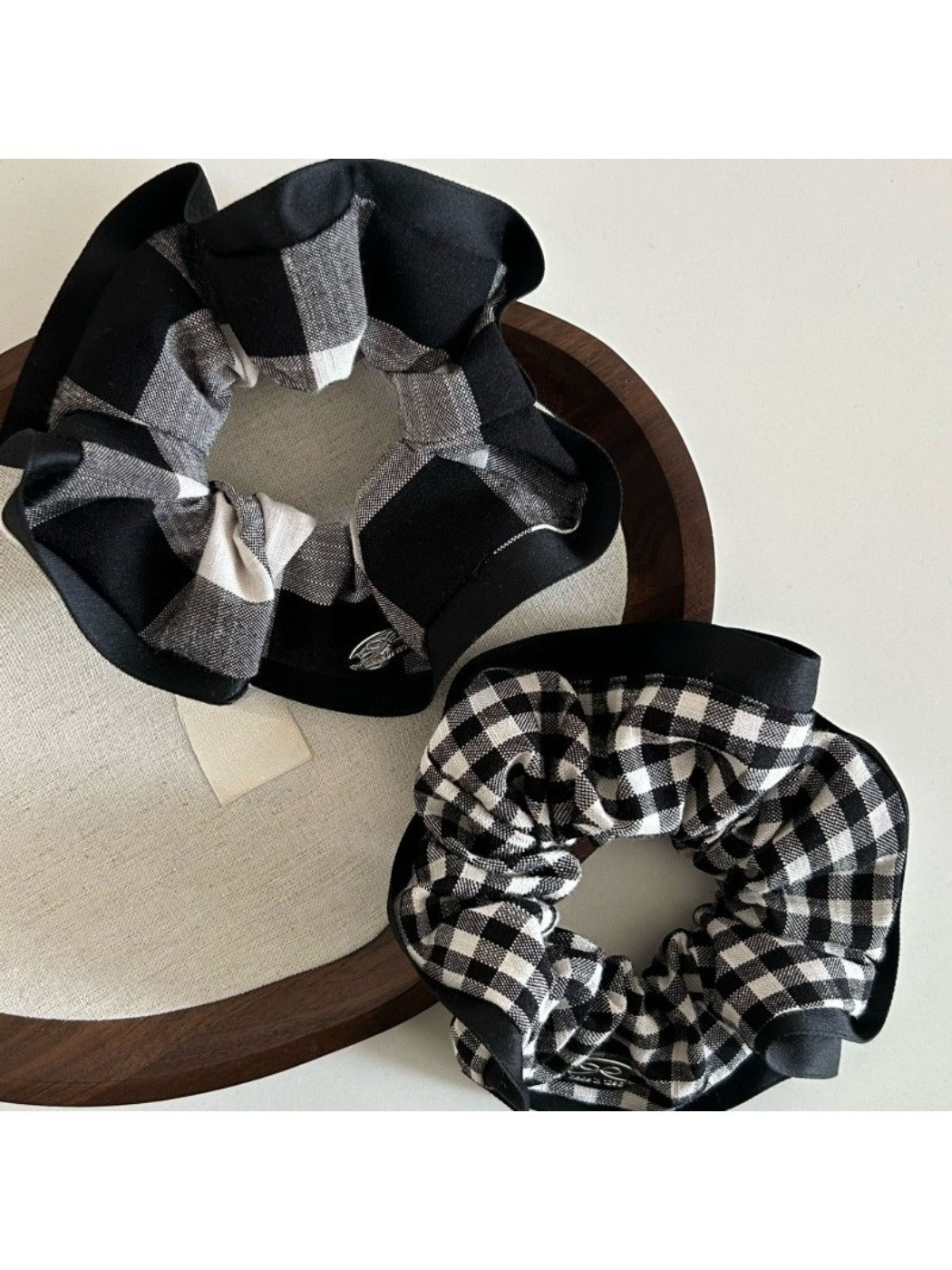 Close-up of black edge detail on black and white check scrunchie fabric
