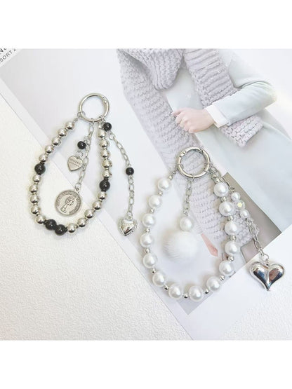 Keypus beaded heart pendant keychain attached to a silver keyring on a white background