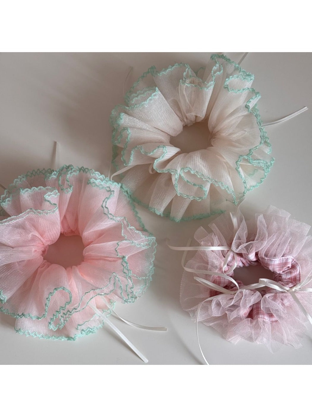 Gifty Ribbon Knot Tulle Scrunchie displayed on a wooden surface with natural light