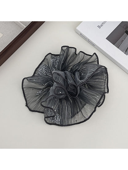Gifty scrunchie displayed flat, showing its full circular shape and texture