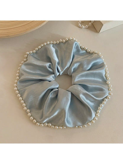 Gifty chic satin scrunchie with pearl beads shown from a side angle