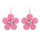 Earedge raffia flower earrings paired with casual outfit on model for styling inspiration