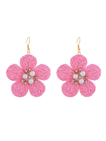 Earedge raffia flower earrings paired with casual outfit on model for styling inspiration