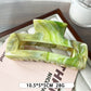 Beau marble pattern square claw clip resting on a wooden surface