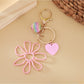 Side angle of raffia hollow flower keychain highlighting its lightweight design
