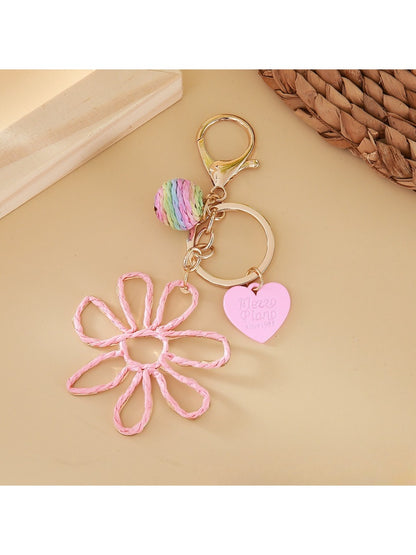 Side angle of raffia hollow flower keychain highlighting its lightweight design