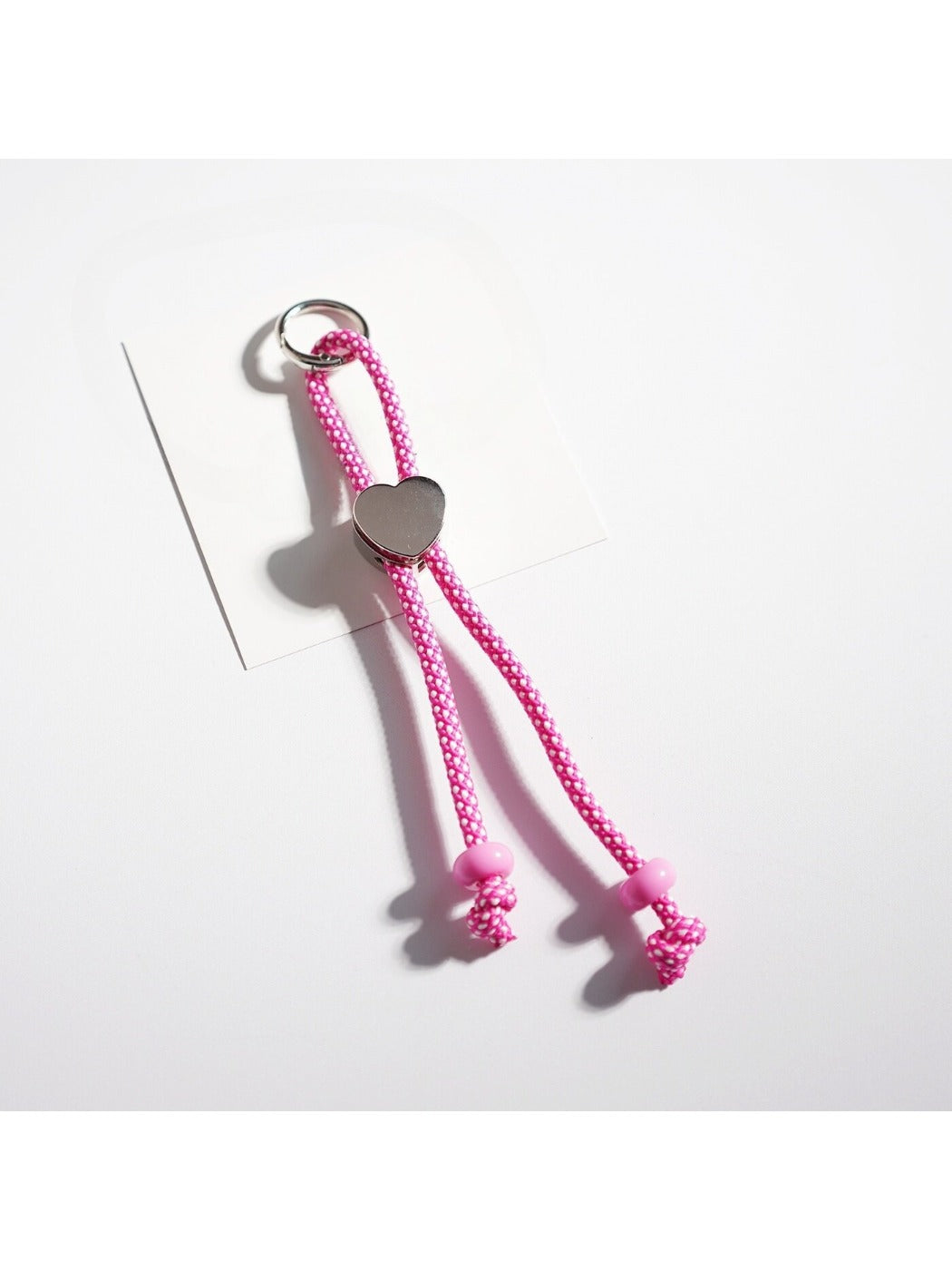Close-up of colorful twisted rope heart keychain with metal keyring