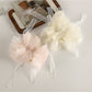 Side view of ruched scrunchie with a delicate bow accent in pastel pink