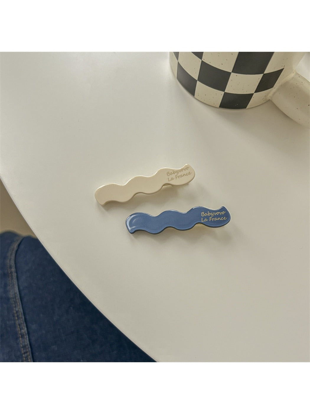 Beau hair clip with blue and white flowers against a plain white background