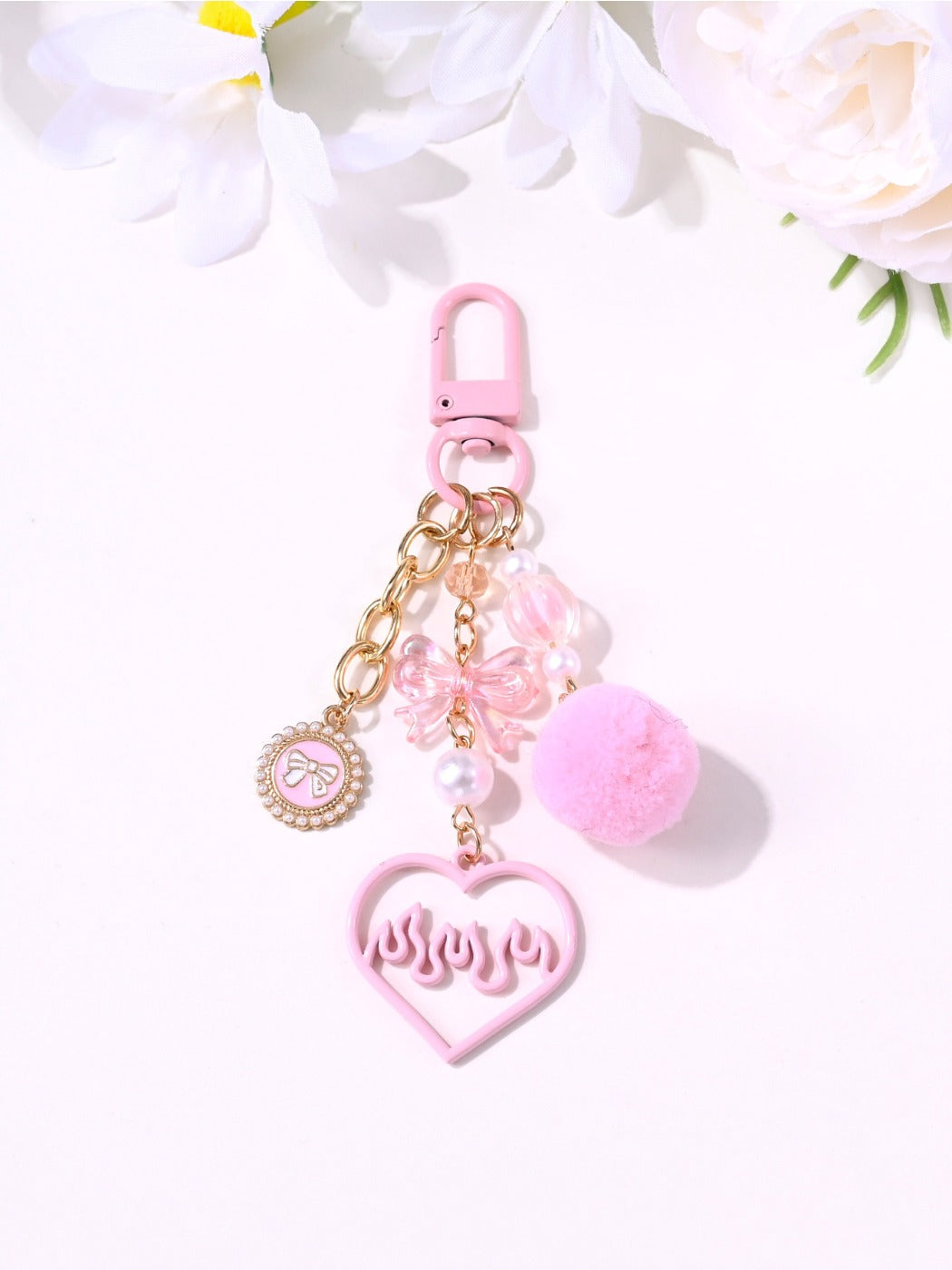 Close-up of the pink heart keychain showing its glossy surface