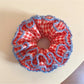 Red plaid scrunchie with ruffled fabric detail on a white background