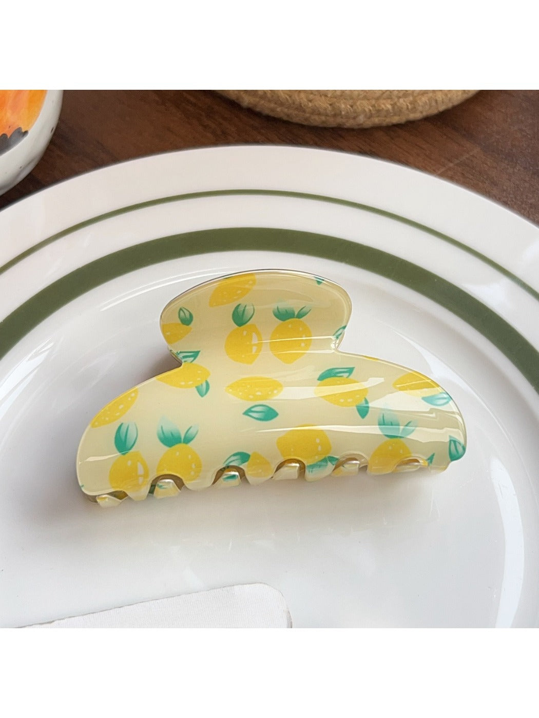 Beau fruit print shark claw clip resting on a wooden surface