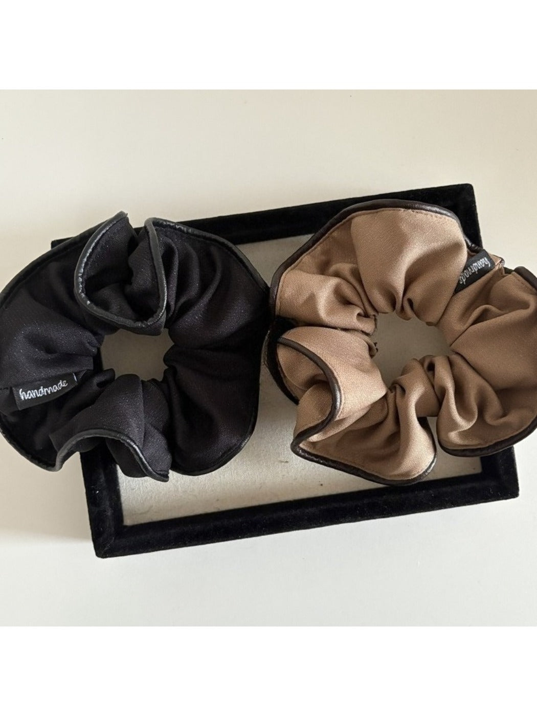 Scrunchie wrapped around a ponytail on a model with smooth hair
