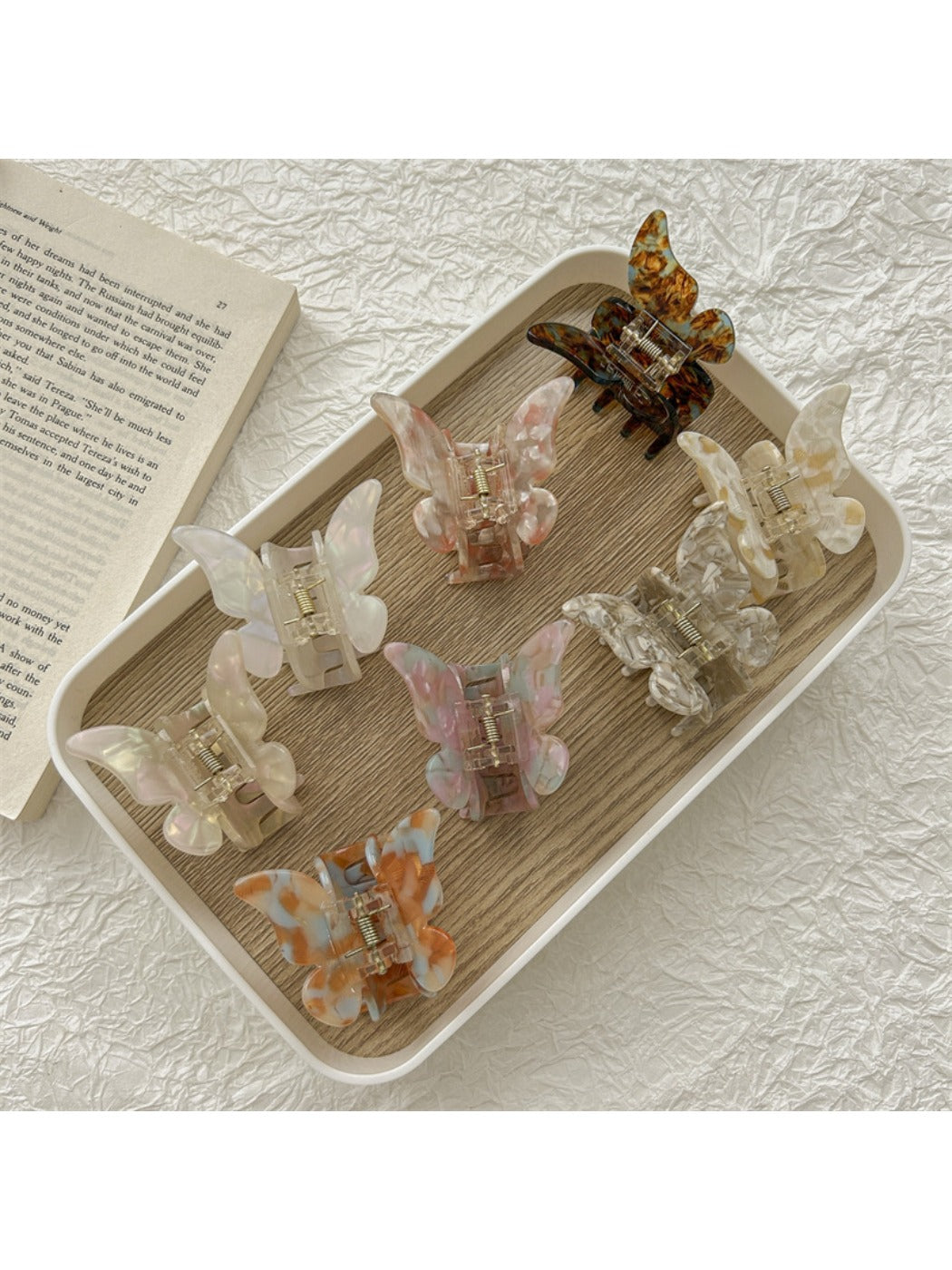 Beau light color butterfly shaped claw clip on white background