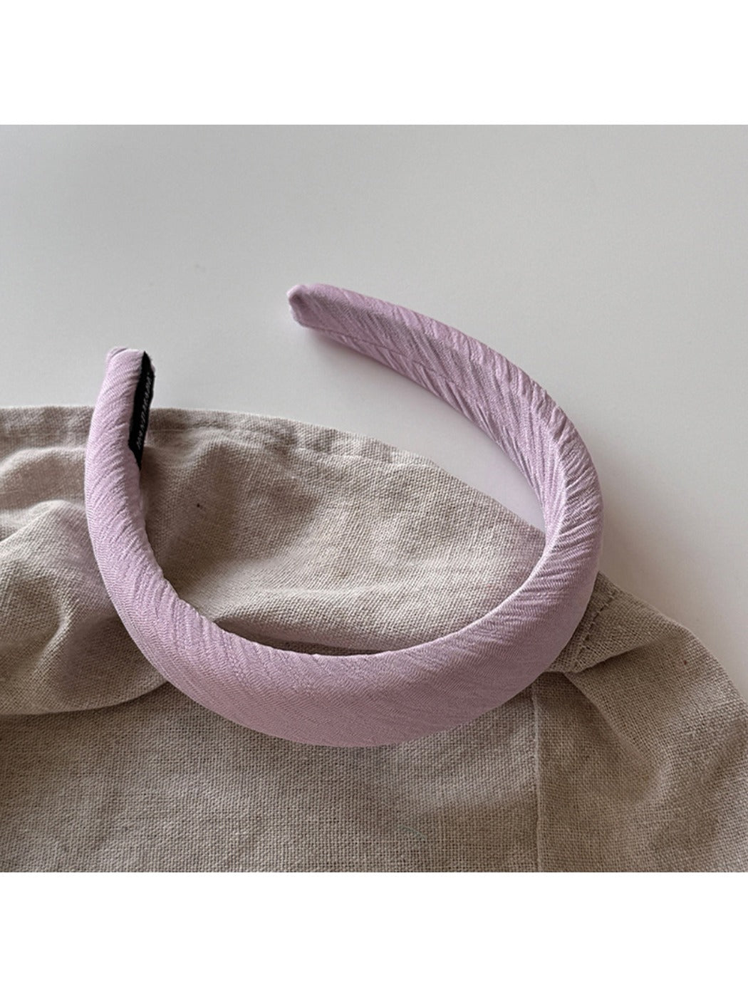 Model wearing purple wide edge headband with casual outfit