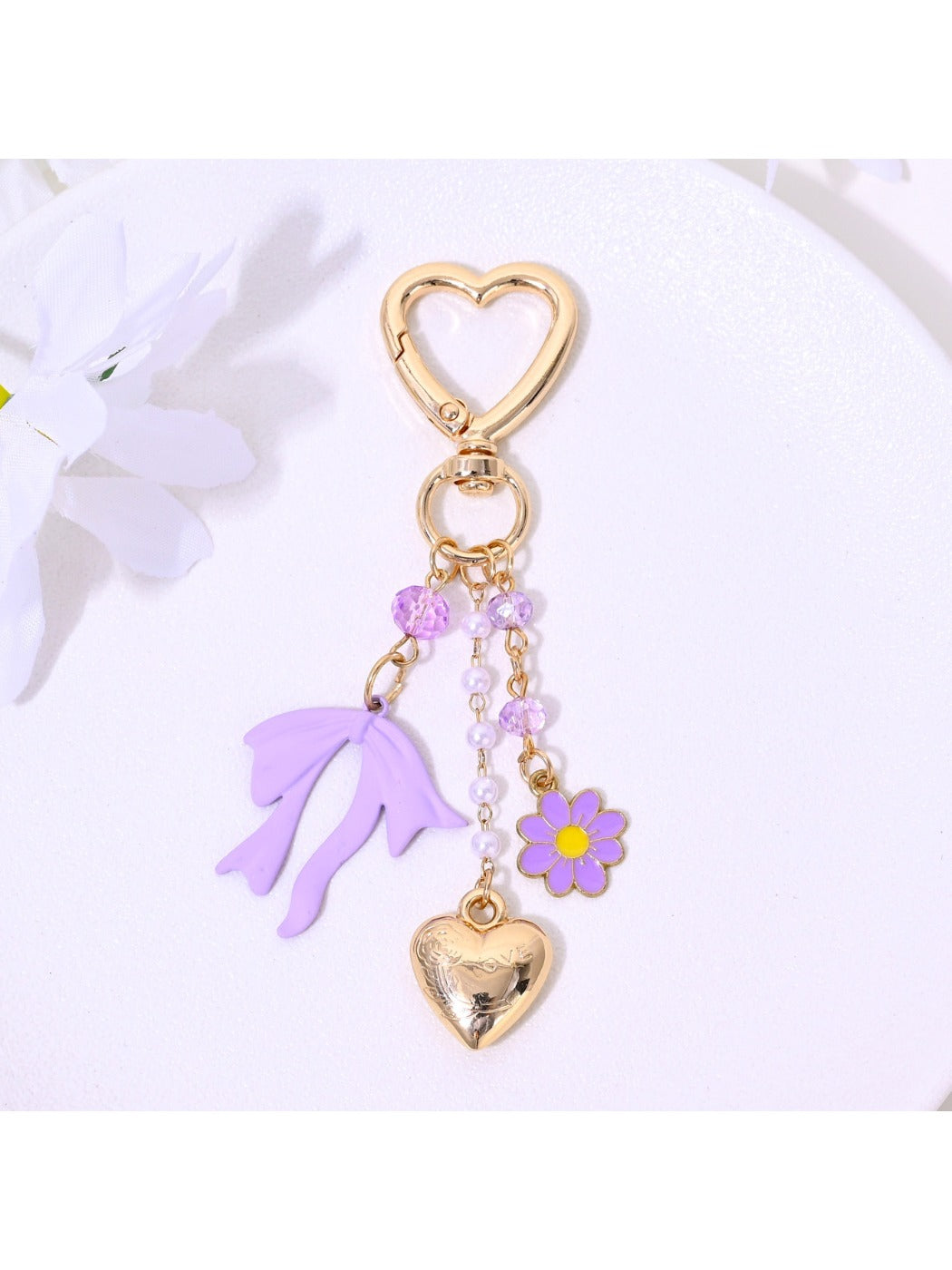 Heart and flower keychain held in hand showing size and detail