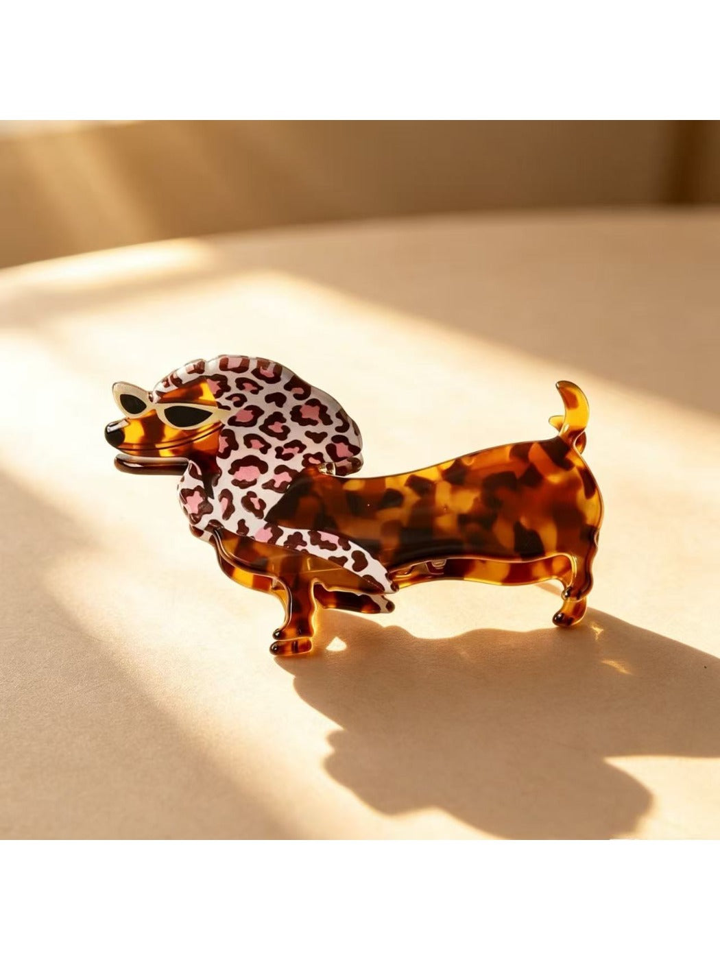 Beau cute cartoon dachshund claw clip resting on white surface