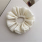 Gifty shimmer scrunchie displayed on white background showing full shape