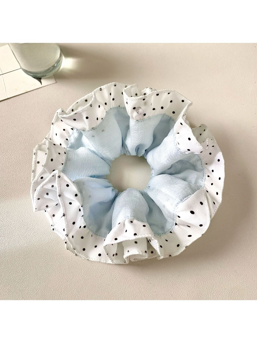 Gifty scrunchie displayed flat highlighting the circular shape and vibrant color blocks