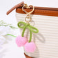 Keypus bouquet shaped keychain hanging from a bag zipper with clear floral details