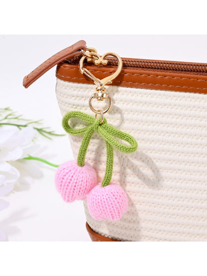 Keypus bouquet shaped keychain hanging from a bag zipper with clear floral details