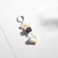 Flat lay of Keypus cute bow heart beaded keychain with metal keyring