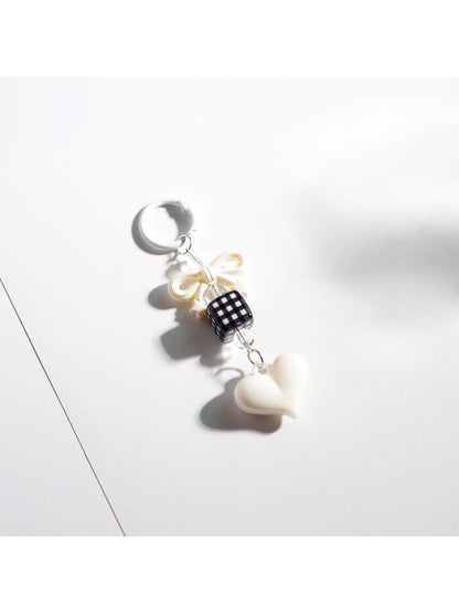 Flat lay of Keypus cute bow heart beaded keychain with metal keyring