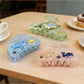 Close-up of Beau Coastal Ocean Series acetate hair clip showing glossy finish and ocean colors
