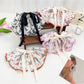Beau Chic Sweet Bow Hair Clip in soft pink fabric with gold accents on white background