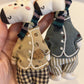 Giraffe charm keychain hanging from a handbag strap