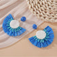 Earedge fan shaped drop earrings photographed with soft natural lighting