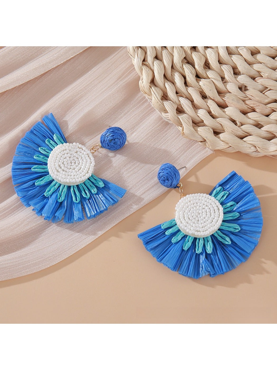 Earedge fan shaped drop earrings photographed with soft natural lighting