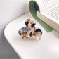 Beau vintage small crescent shaped claw clip styled in hair on model with dark hair
