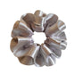 Side view of silver satin double layer ruffle scrunchie
