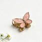 Beau butterfly hair clip in pastel yellow held in hand to show size