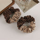 Gifty scrunchie styled on a wrist as a fashion accessory with retro vibe