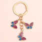 Side view of color block butterfly keychain highlighting its thickness and metal ring
