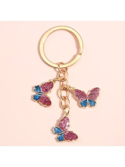 Side view of color block butterfly keychain highlighting its thickness and metal ring