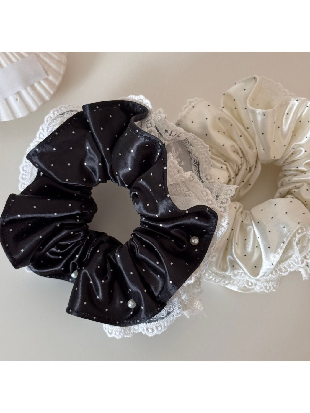 Close-up of Gifty polka dot scrunchie showing fabric texture and elastic band