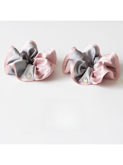 Close-up of Gifty scrunchie showing smooth fabric and color block pattern