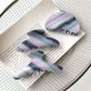 Close-up of Beau purple hair claw clip showing curved teeth design