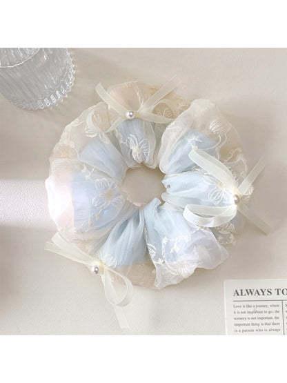 Gifty scrunchie displayed on a white background showing bow detail and fabric texture