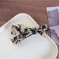 Top view of Beau acetate bow hair clip showing symmetrical bow design