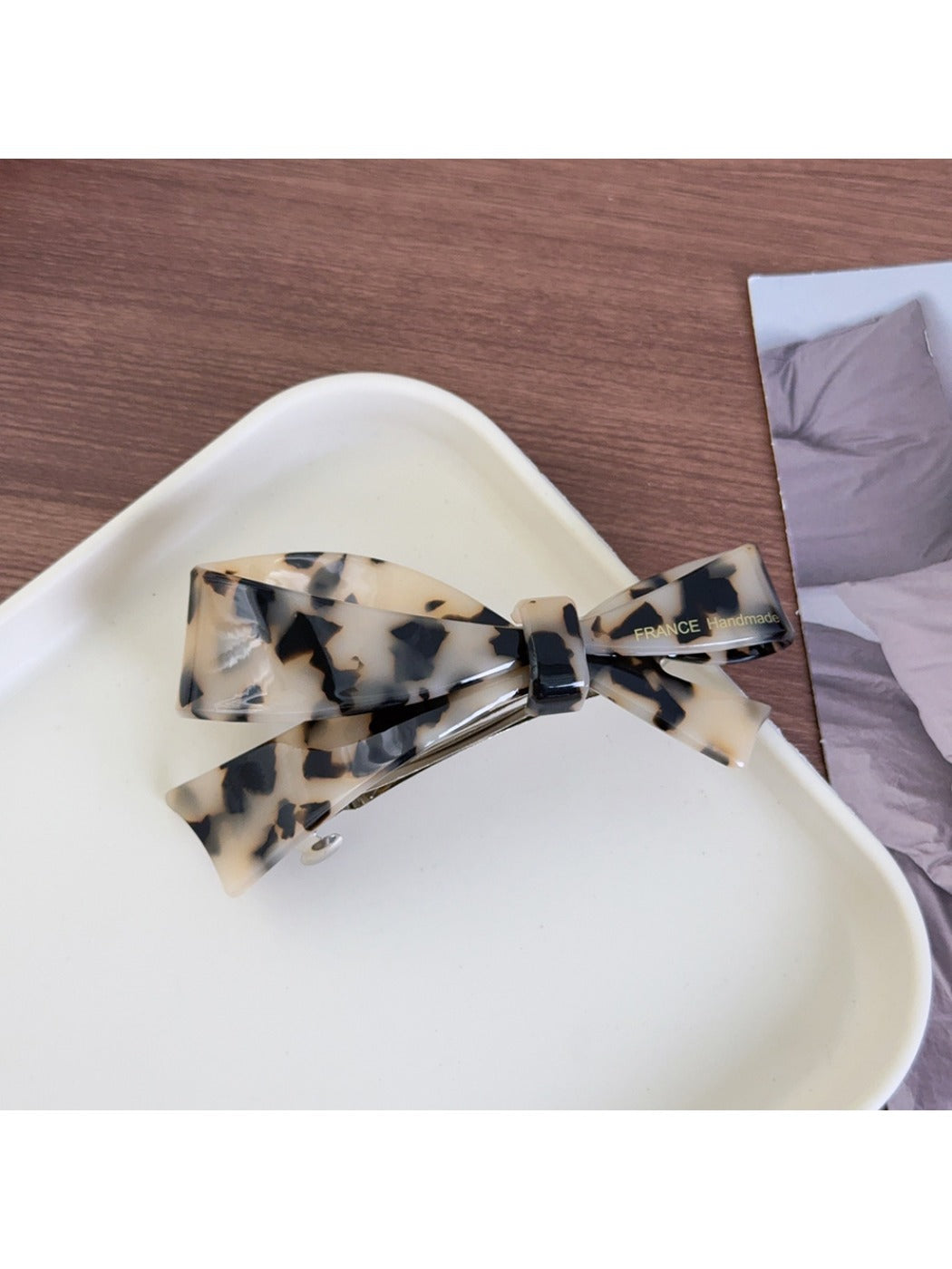 Top view of Beau acetate bow hair clip showing symmetrical bow design